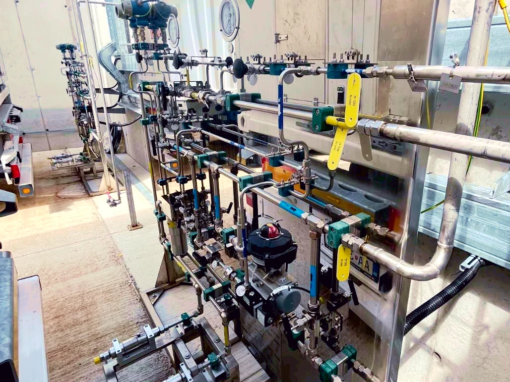 Detailed view of hydrogen process piping, valves, and control instrumentation in an industrial setup