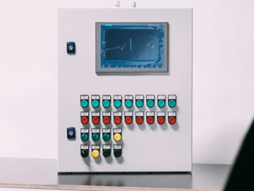 Custom industrial control panel with Siemens HMI display designed and assembled by AMI engineers in Latvia.